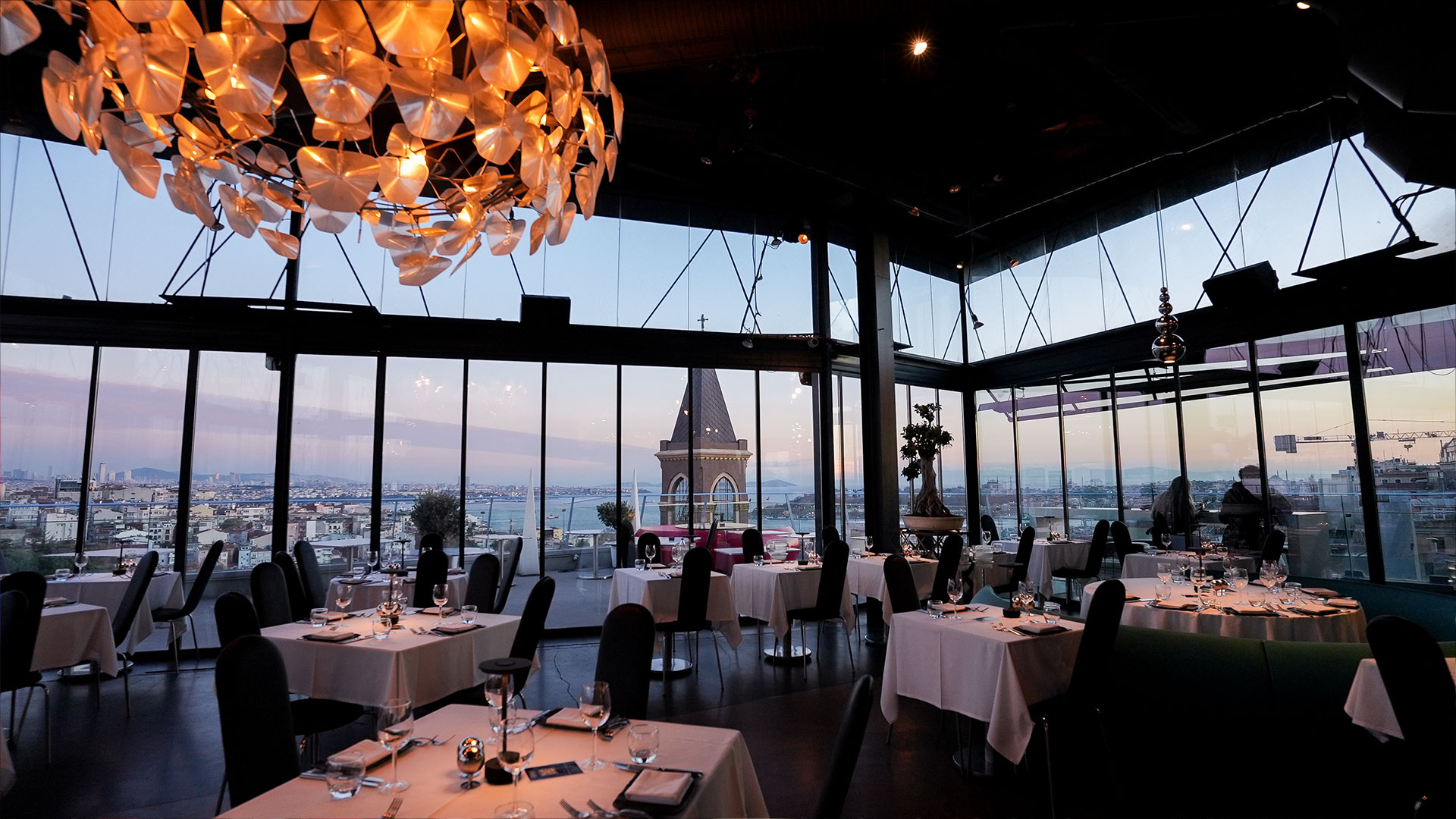 360 Istanbul's dining room with panoramic Bosphorus views at dusk