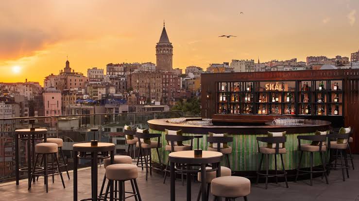 Sky Karaköy's rooftop bar with the Galata Tower and skyline behind it